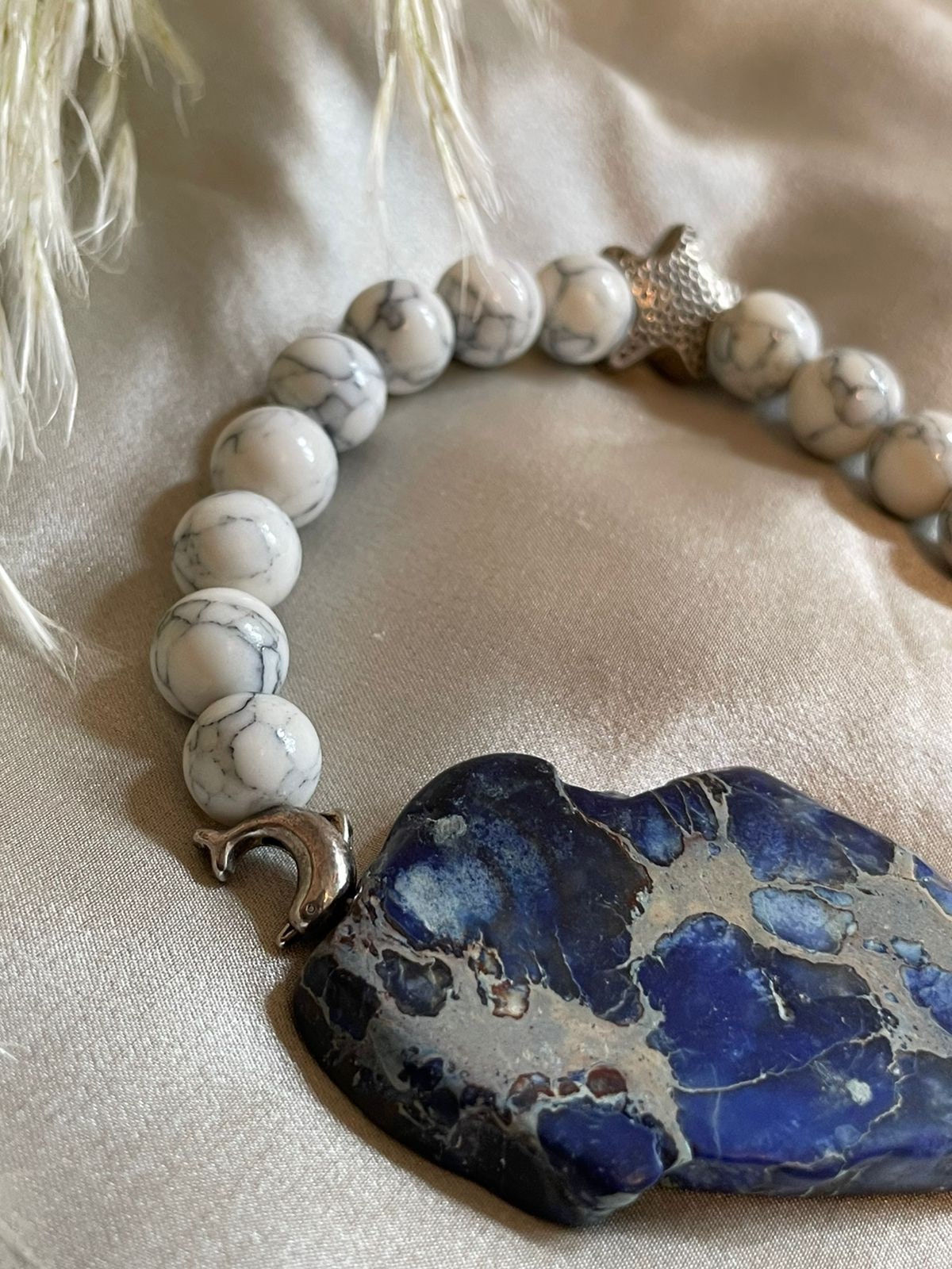 Natural Variscite slice and Howlite beads elasticated bracelet with Dolphins silver metal spacers. Gemstone bracelet for a woman.