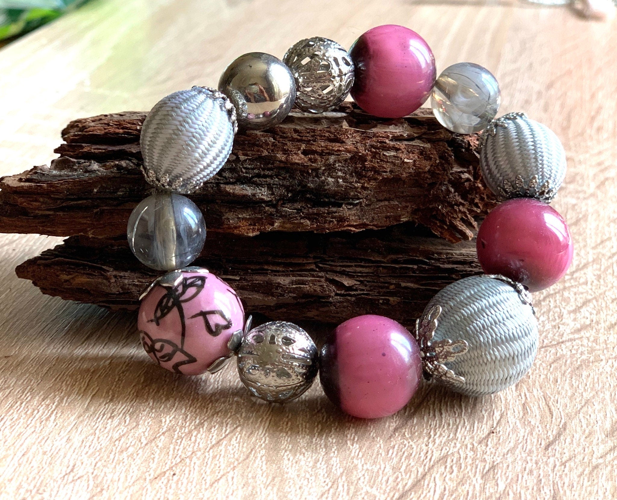 Pink, grey and silver colours various shape, size and materials elasticated vintage bracelet. Boho bracelet for a woman. Gift for her.