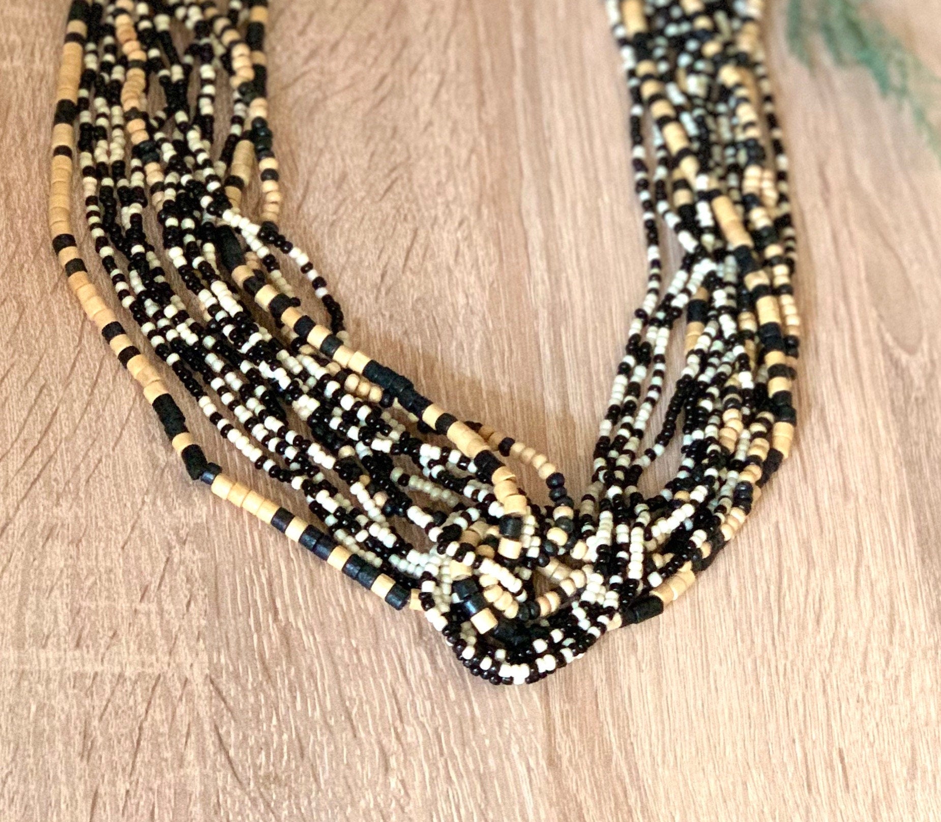 Very interesting multi strand black and beige wooden heishi beads and black and white seed beads long adjustable boho style necklace