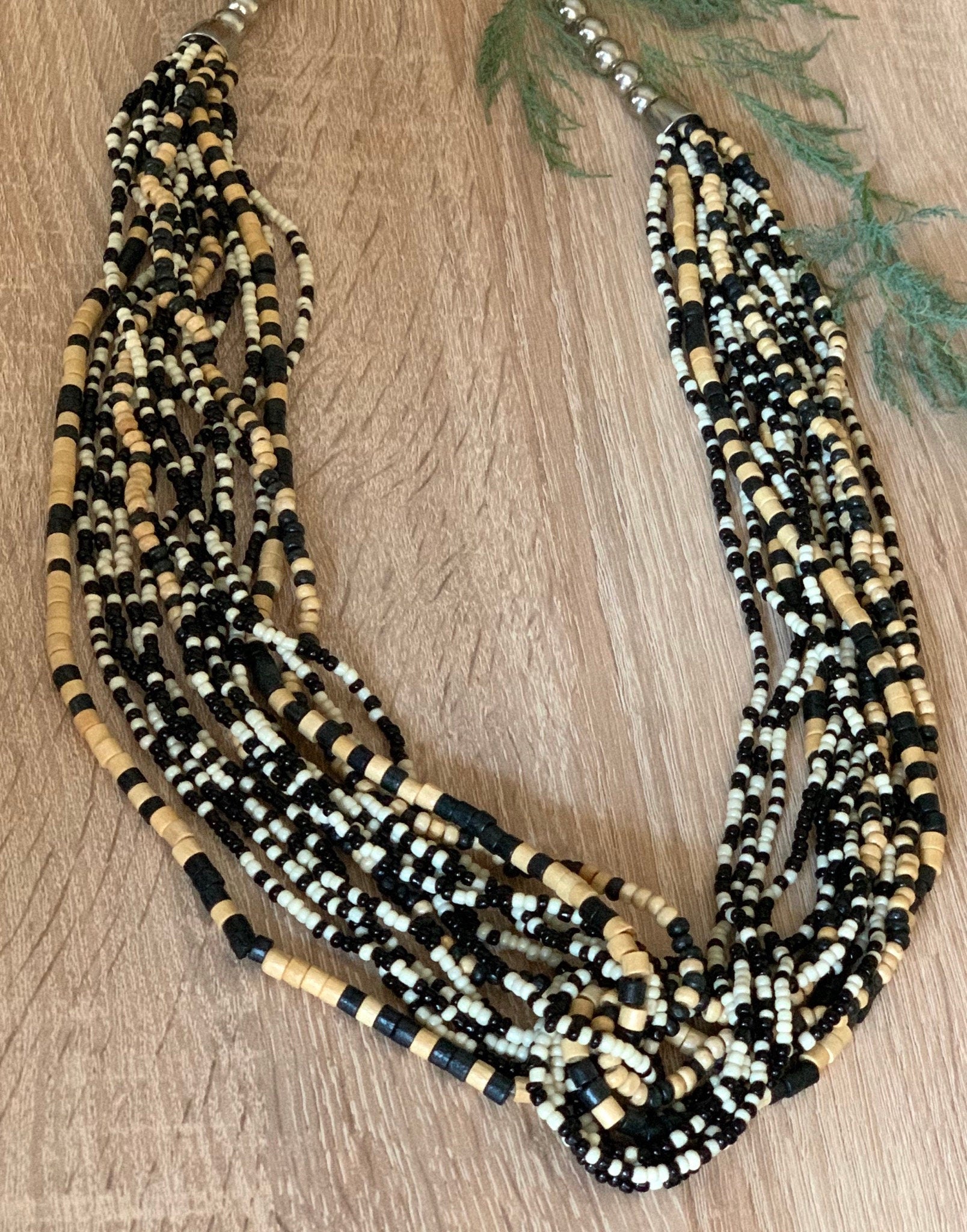 Very interesting multi strand black and beige wooden heishi beads and black and white seed beads long adjustable boho style necklace