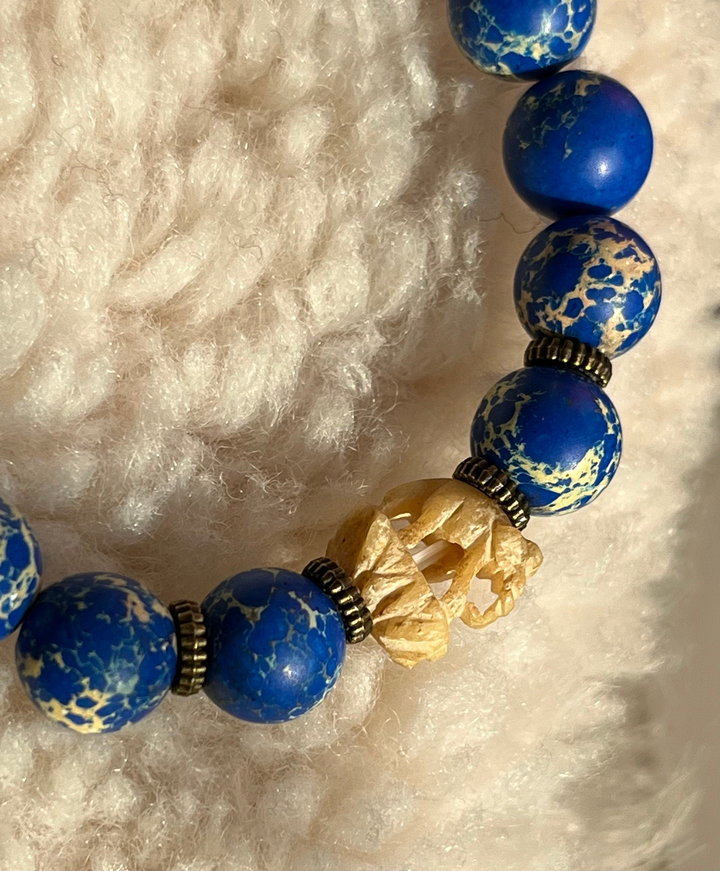 Natural ultramarine blue Variscite ( Ocean Jasper) beaded elasticated bracelet with a vintage carved Indian Elephant and brass Angel spacers