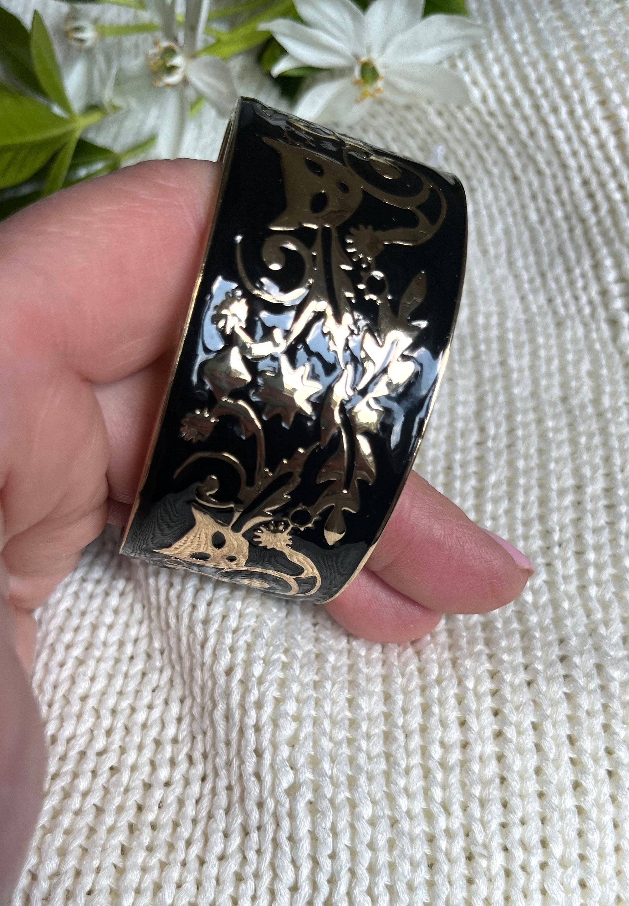 Stunning black enamel on gold metal vintage bangle bracelet with a carved cat mask images on it. Bracelet for a woman. Gift for her.