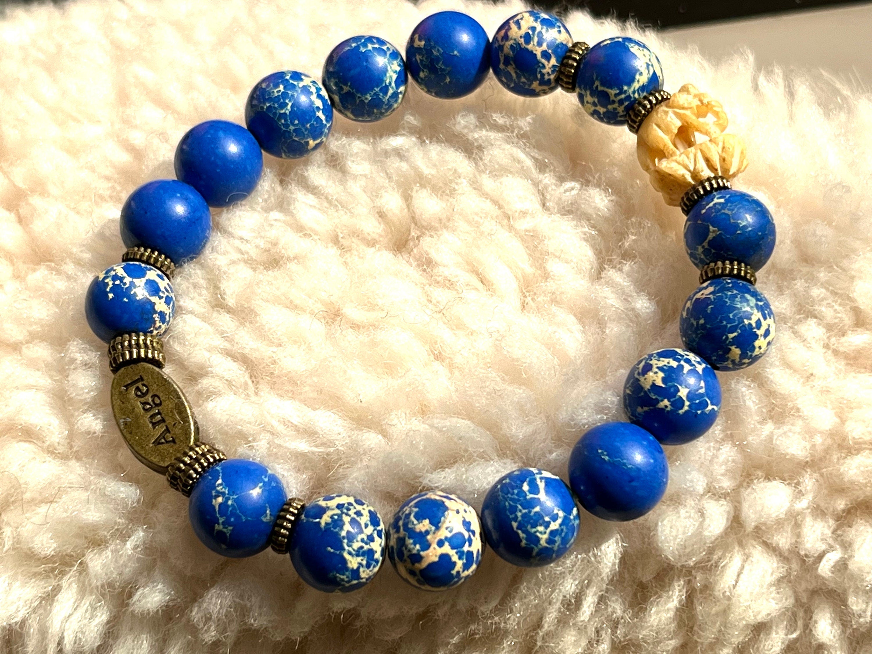 Natural ultramarine blue Variscite ( Ocean Jasper) beaded elasticated bracelet with a vintage carved Indian Elephant and brass Angel spacers