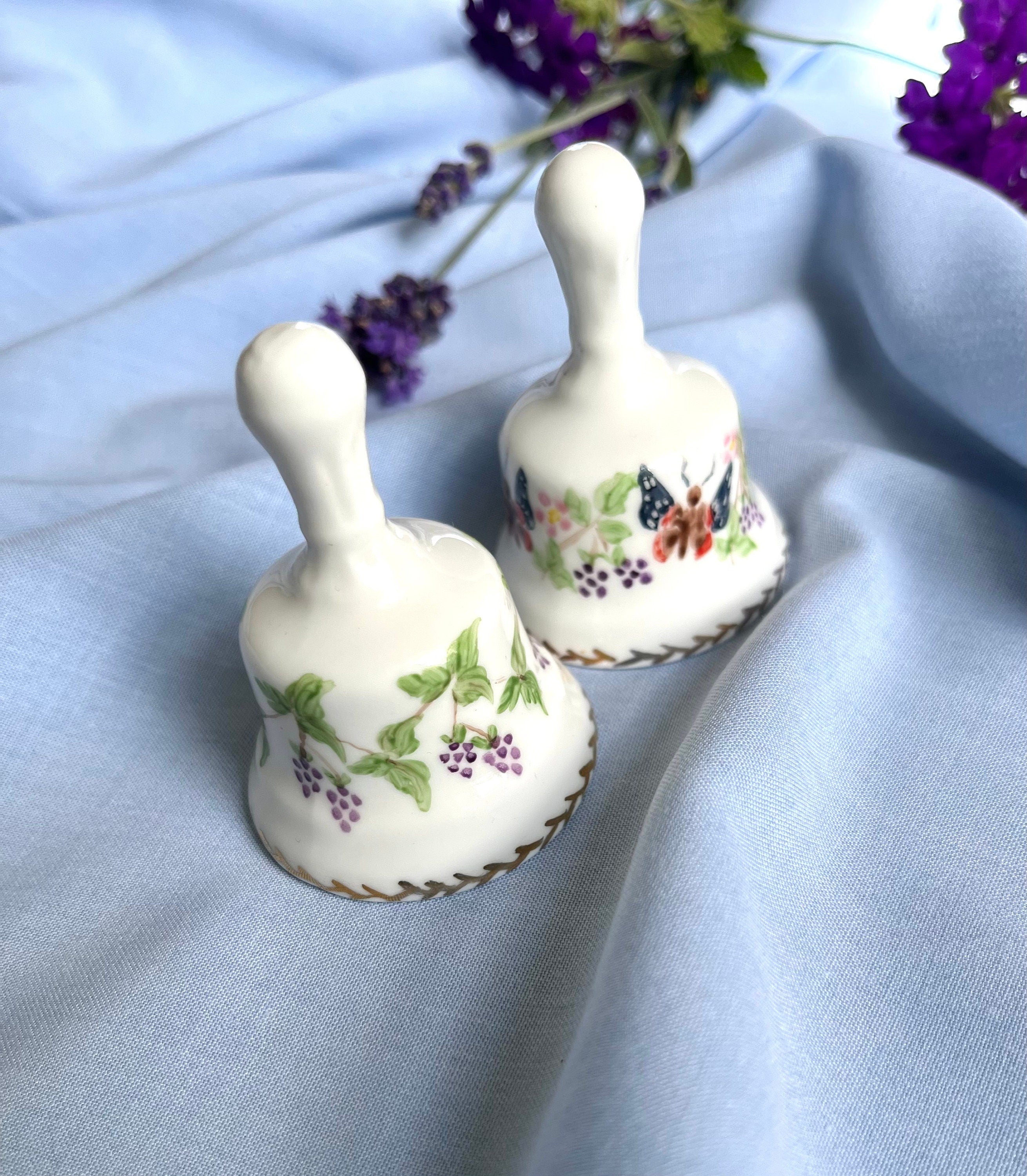 A pair of signed by artist Agneta Hickley vintage 90s white porcelain bells with butterflies and berries patterns. Collectible gift unisex