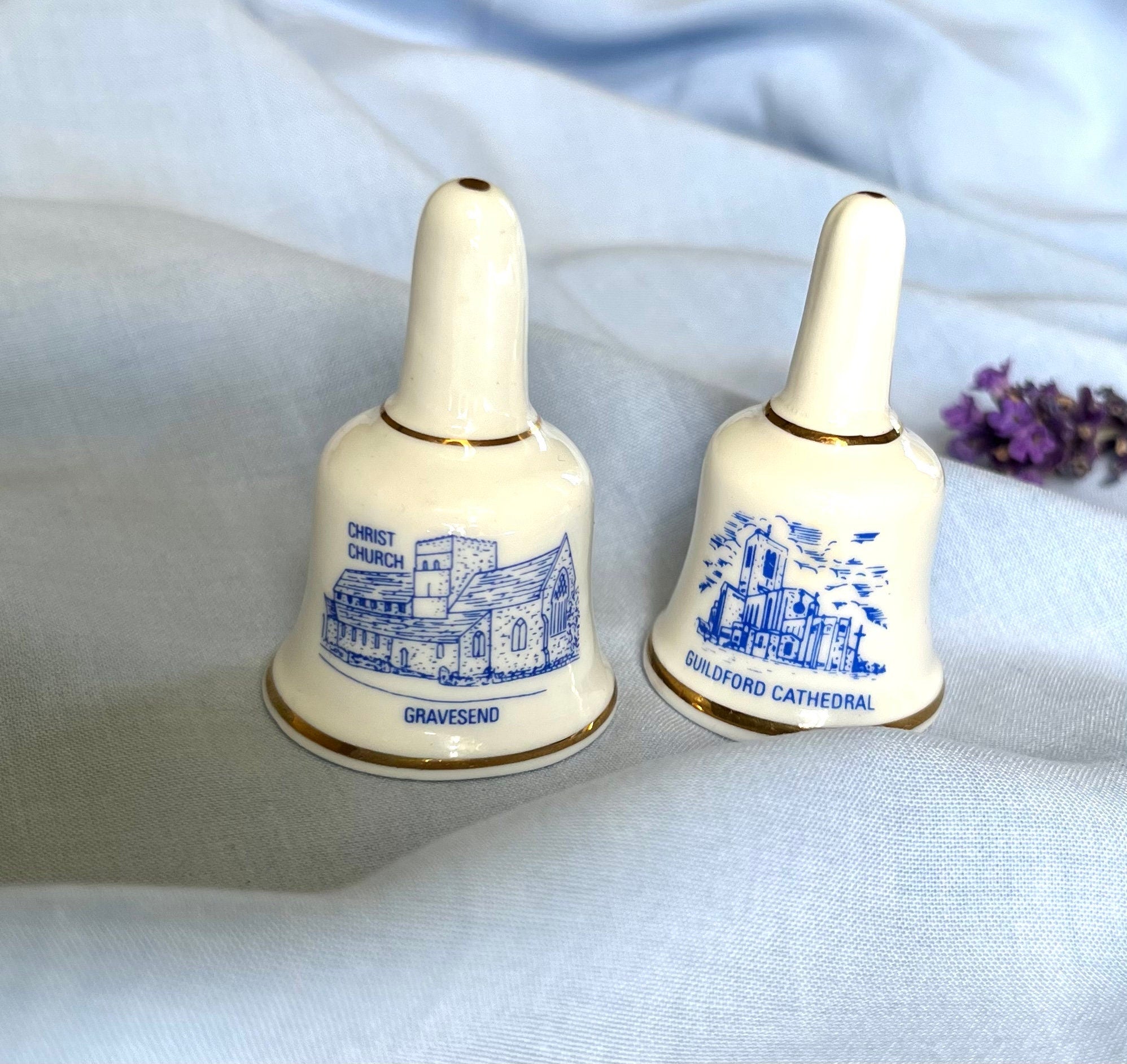 A pair of English heritage fine bone china bells with blue images and signs of Gravesend and Guildford cathedral. Collectible gift unisex.