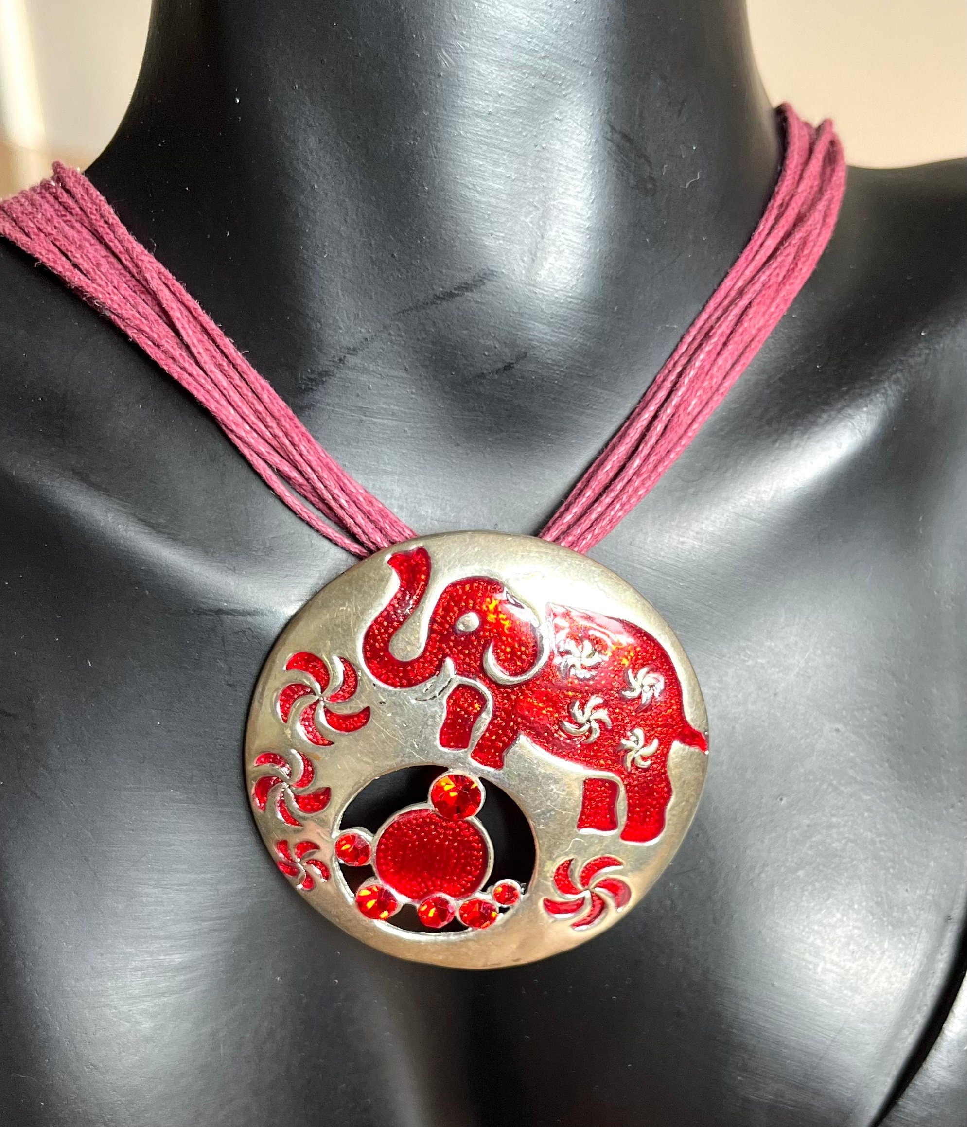 Red Elephant and money bag silver metal, enamel and red crystals amulet pendant on a multi strand cotton cord vintage choker necklace