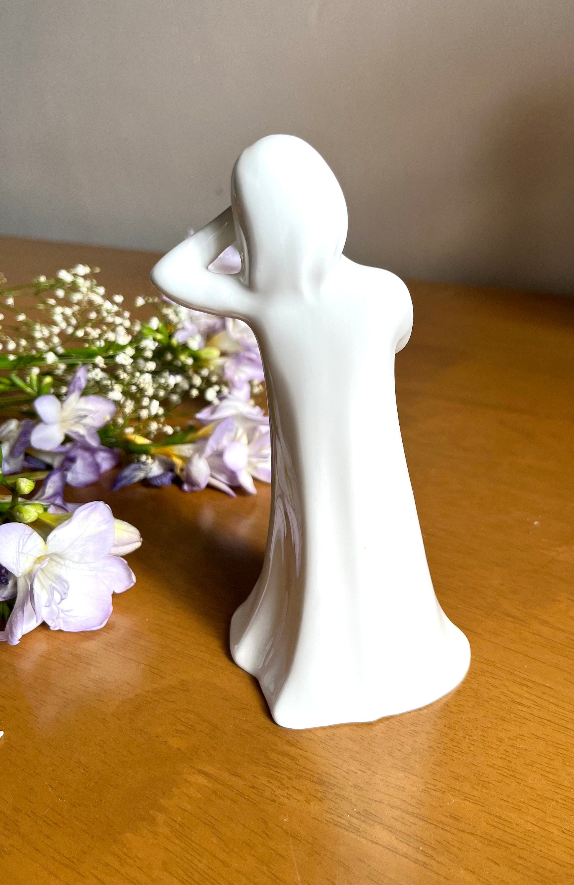 Signed Royal Doulton white bone china figurine of a sleepy girl holding a Teddy bear. Vintage collectible souvenir. Home decor. Gift unisex.