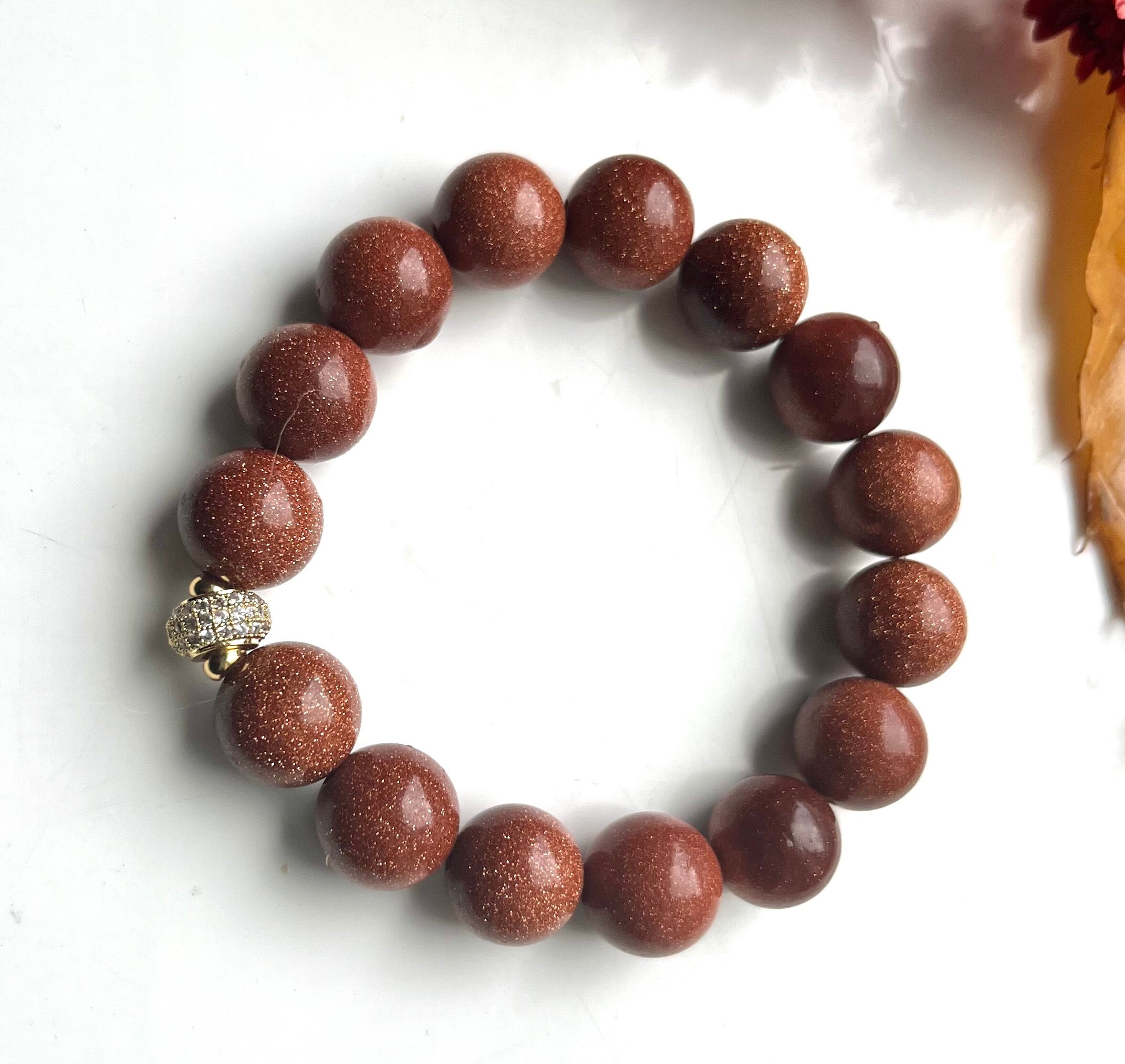 Natural orange Sandstone 12 mm beads elasticated bracelet with a quality gilded brass and rhinestones spacer bead. Handmade gift for her