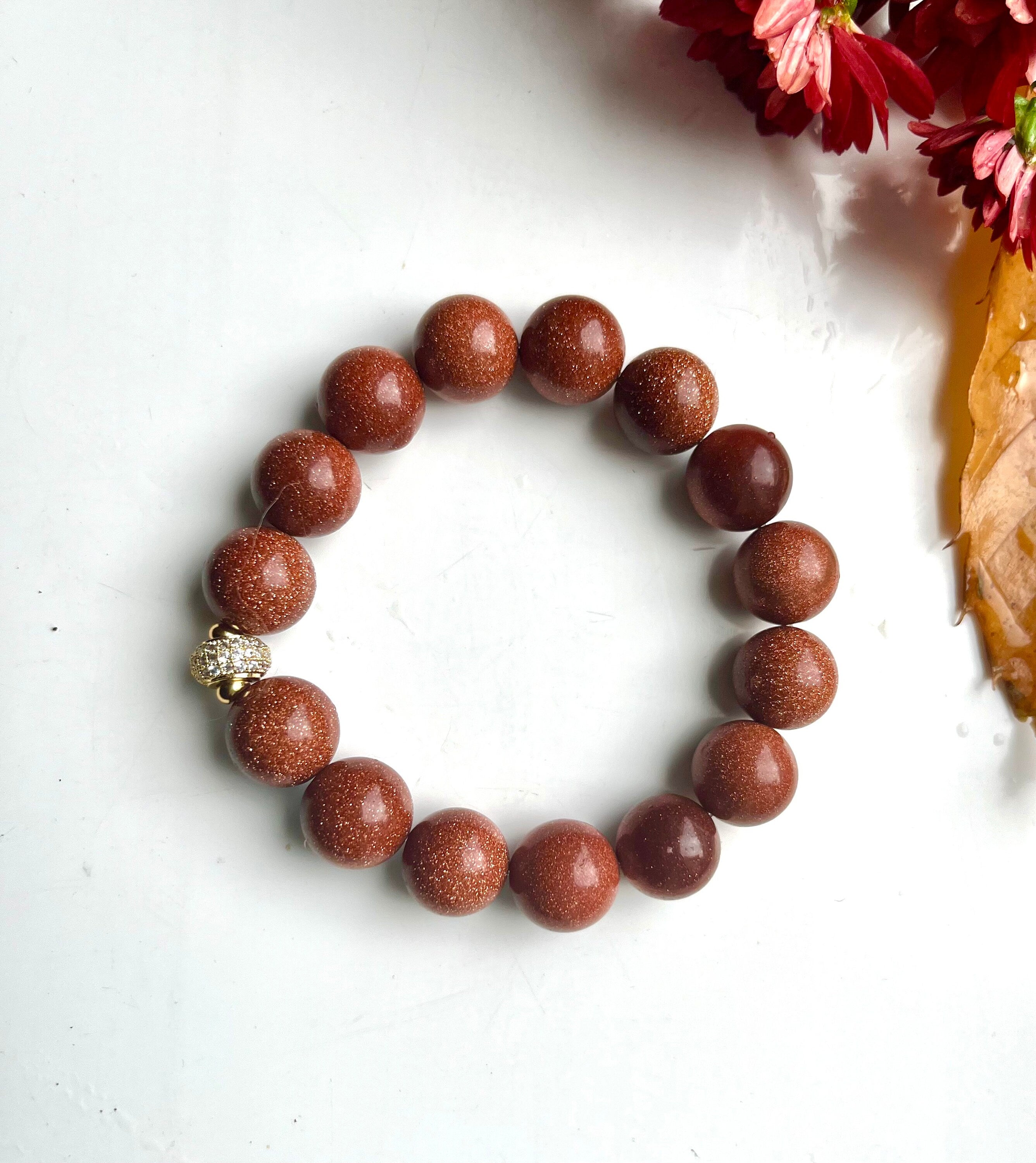 Natural orange Sandstone 12 mm beads elasticated bracelet with a quality gilded brass and rhinestones spacer bead. Handmade gift for her