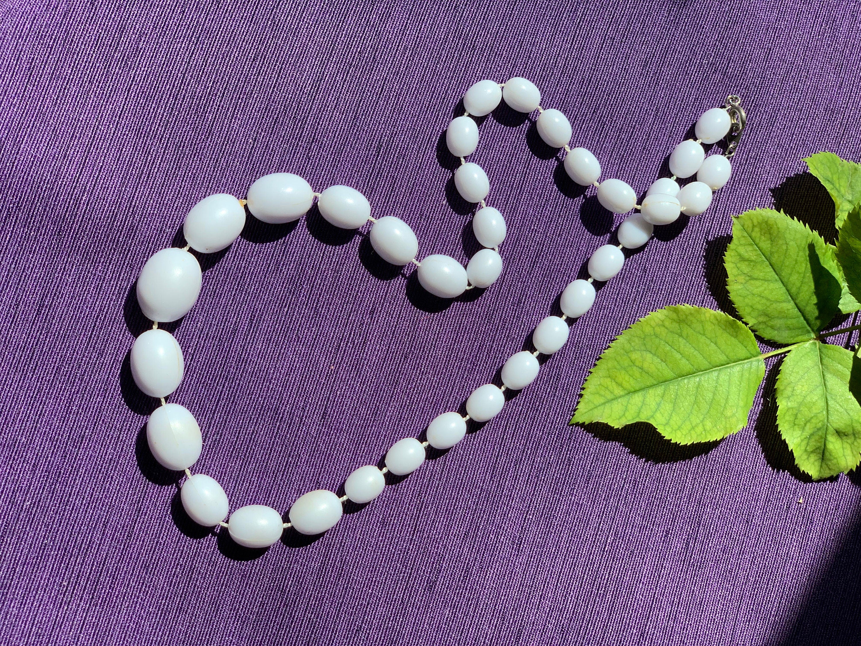 White plastic olive shape beads vintage necklace for a woman. Gift for her. Sealed on a thread beads necklace.