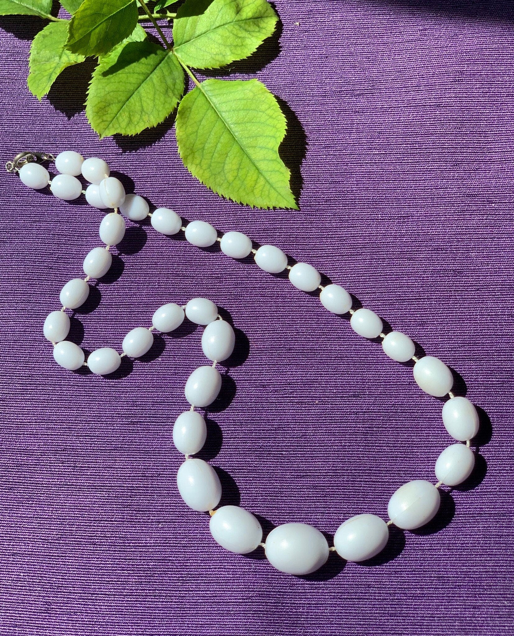 White plastic olive shape beads vintage necklace for a woman. Gift for her. Sealed on a thread beads necklace.