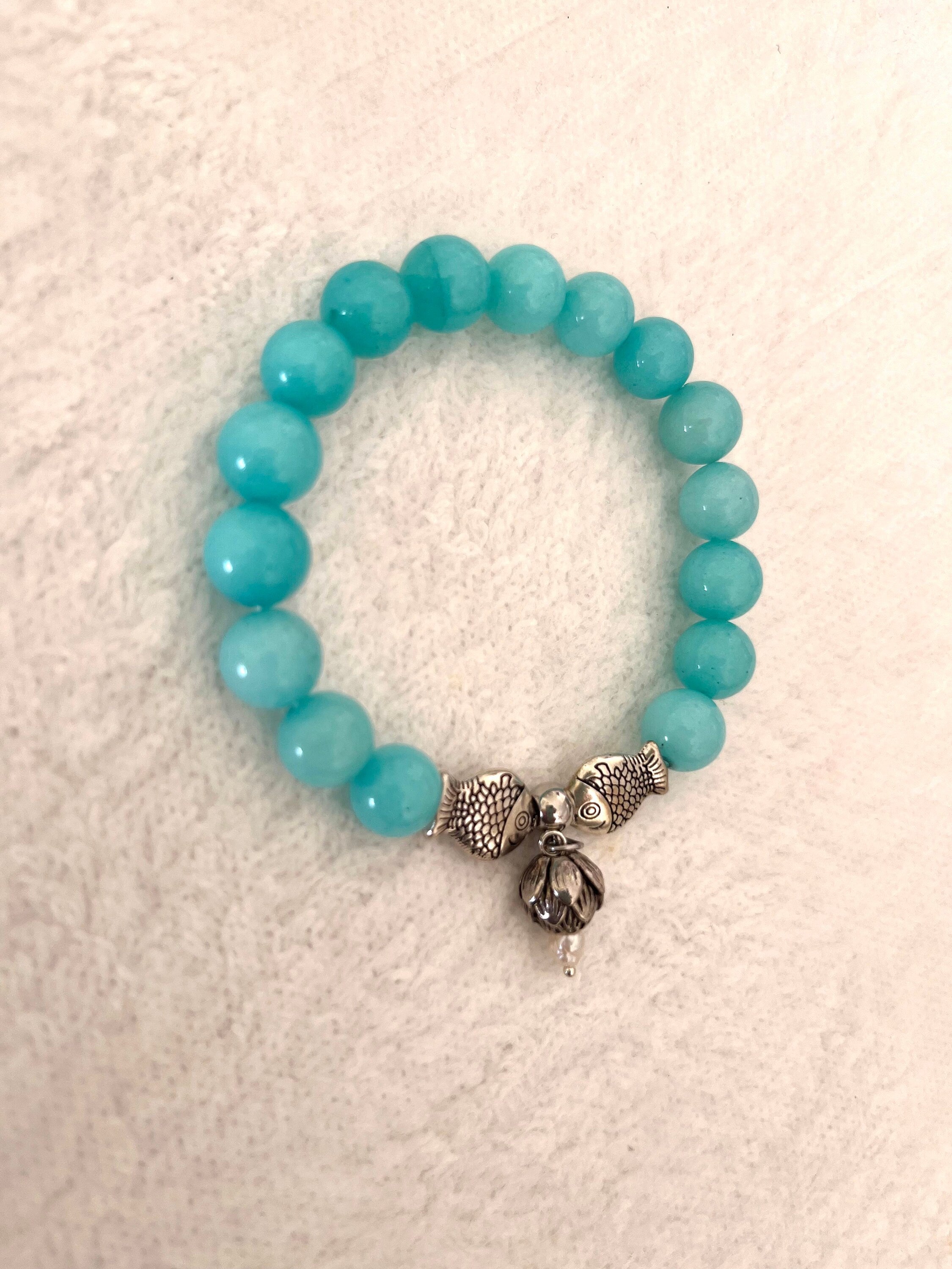 Natural white tinted to turquoise colour Jade Bracelet with Steel Fish spacers and Lotus flower charm. Reiki amulet. Handmade Gift for Her.