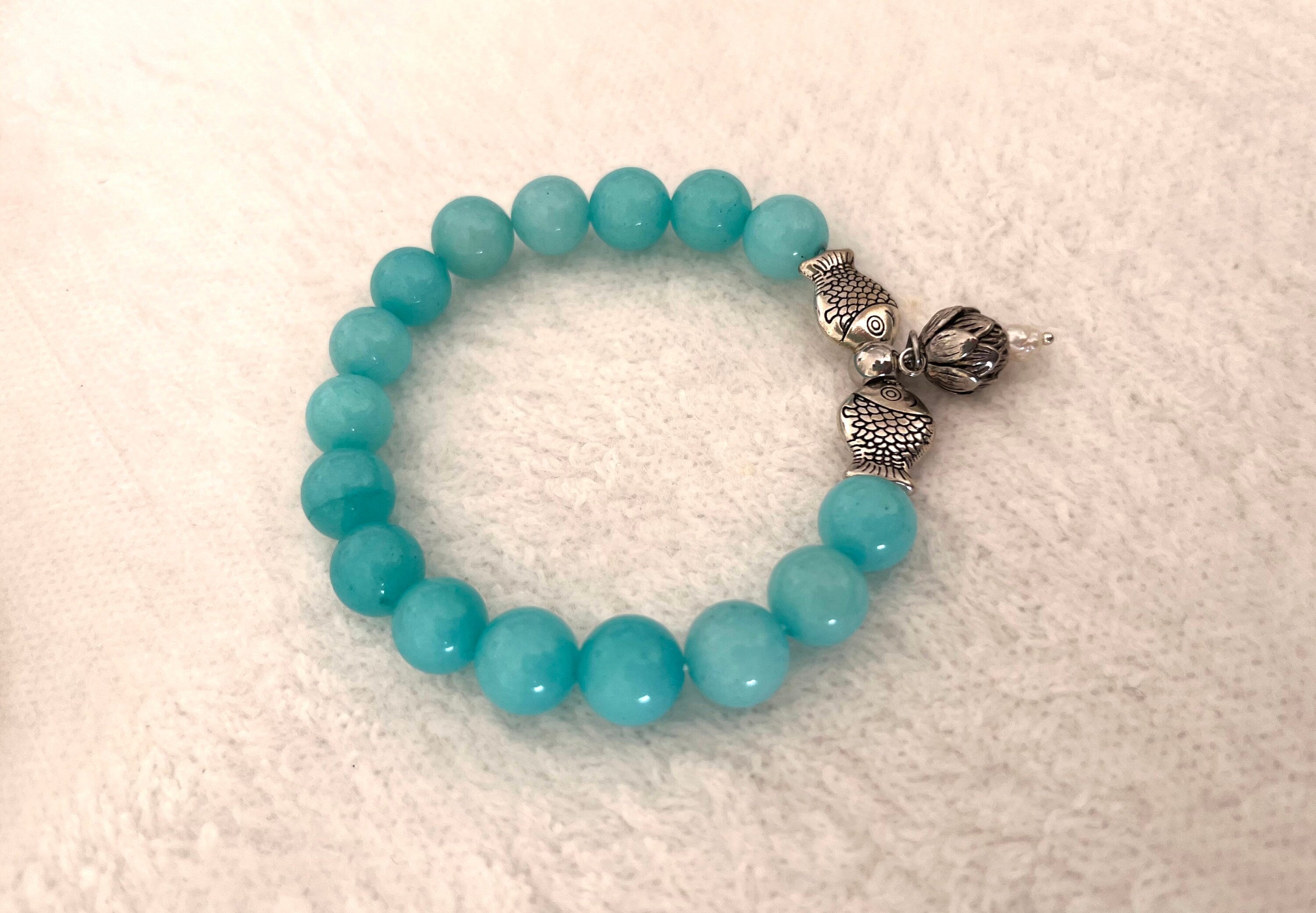 Natural white tinted to turquoise colour Jade Bracelet with Steel Fish spacers and Lotus flower charm. Reiki amulet. Handmade Gift for Her.